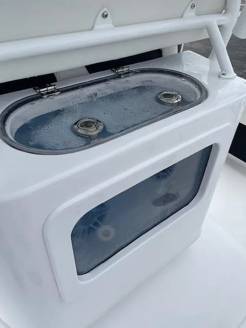 Slide: The Image of 2025 Tidewater 2500 Carolina Bay livewell with clear viewing window and secure latches. - 15