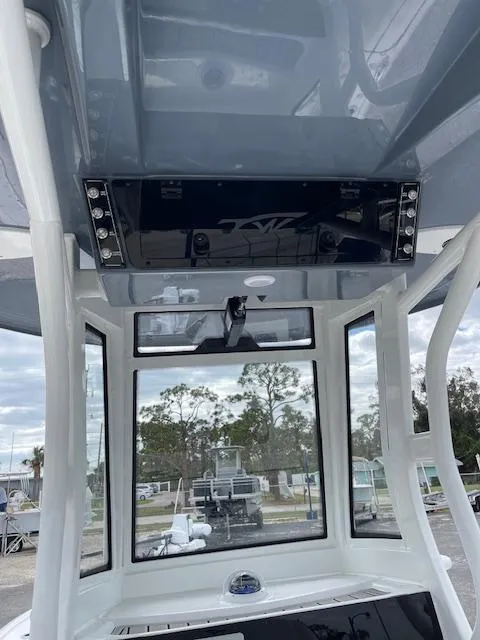 Slide: The Image of 2025 Tidewater 2500 Carolina Bay boat interior with modern console and panoramic windows. - 17