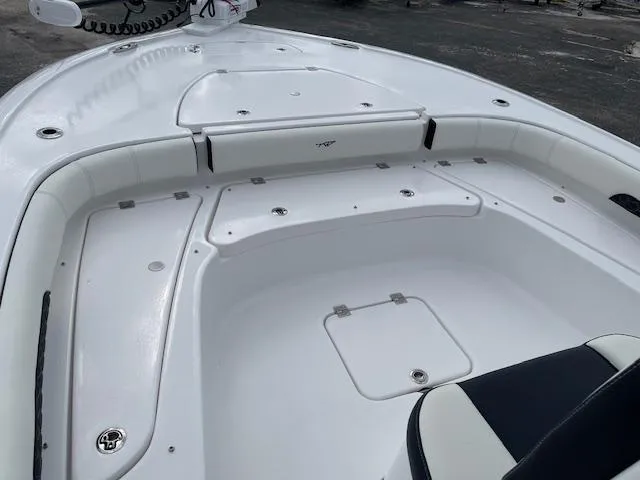 Slide: The Image of 2025 Tidewater 2500 Carolina Bay boat interior with seating and storage compartments. - 18