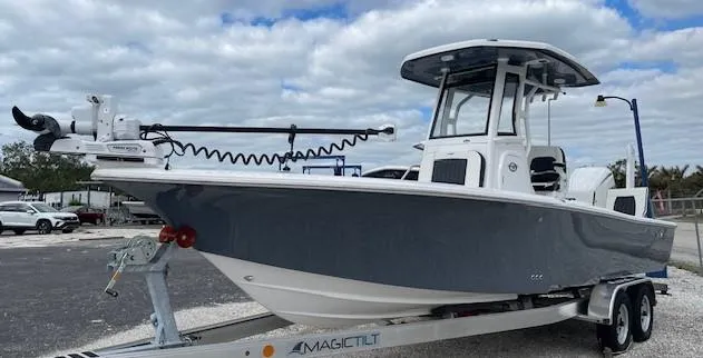 The Image of 2025 Tidewater 2500 Carolina Bay boat on trailer, under cloudy sky. - 2