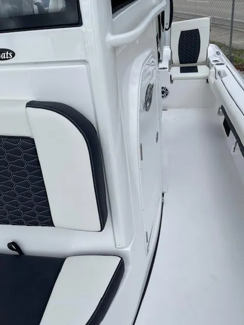 Slide: The Image of 2025 Tidewater 2500 Carolina Bay boat interior with white and black seating. - 22