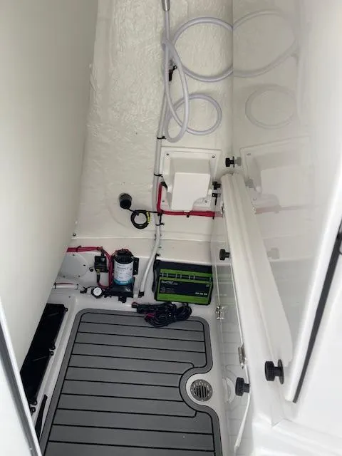 Slide: The Image of Interior view of 2025 Tidewater 2500 Carolina Bay boat, showcasing equipment and storage area. - 24