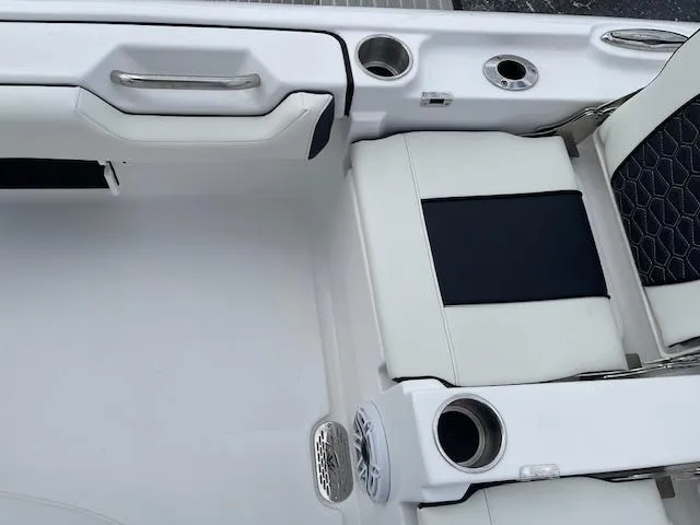 Slide: The Image of 2025 Tidewater 2500 Carolina Bay boat interior with white seating and cup holders. - 28