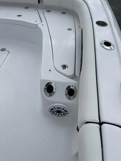 Slide: The Image of 2025 Tidewater 2500 Carolina Bay boat interior with rod holders and speaker. - 29
