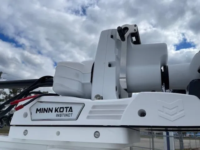 Slide: The Image of Minn Kota Instinct motor on 2025 Tidewater 2500 Carolina Bay boat under cloudy sky. - 33