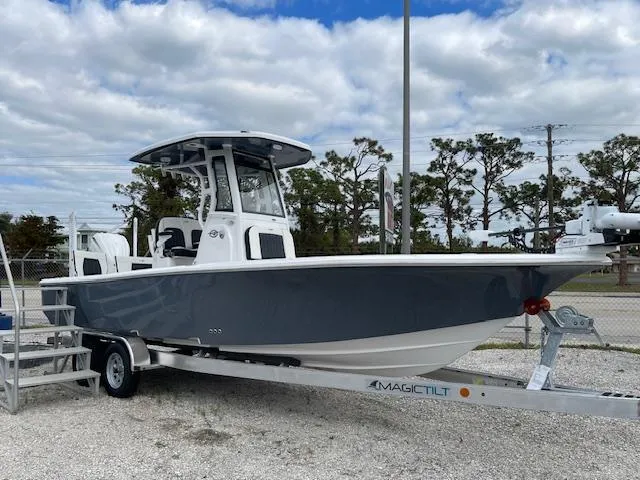 Slide: The Image of 2025 Tidewater 2500 Carolina Bay boat on trailer, parked outdoors under cloudy sky. - 5