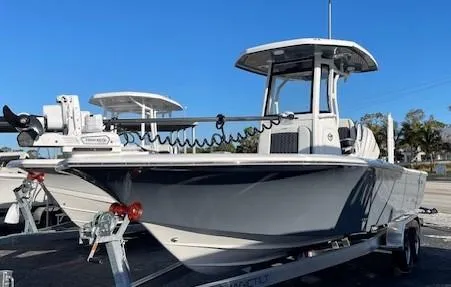 Slide: The Image of 2025 Tidewater 2500 Carolina Bay boat on trailer under clear blue sky. - 8