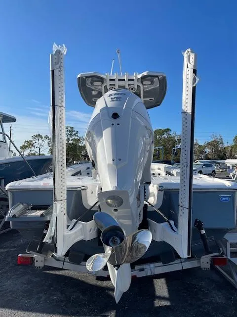 Slide: The Image of 2025 Tidewater 2500 Carolina Bay boat, rear view with motor and propeller, under clear blue sky. - 9