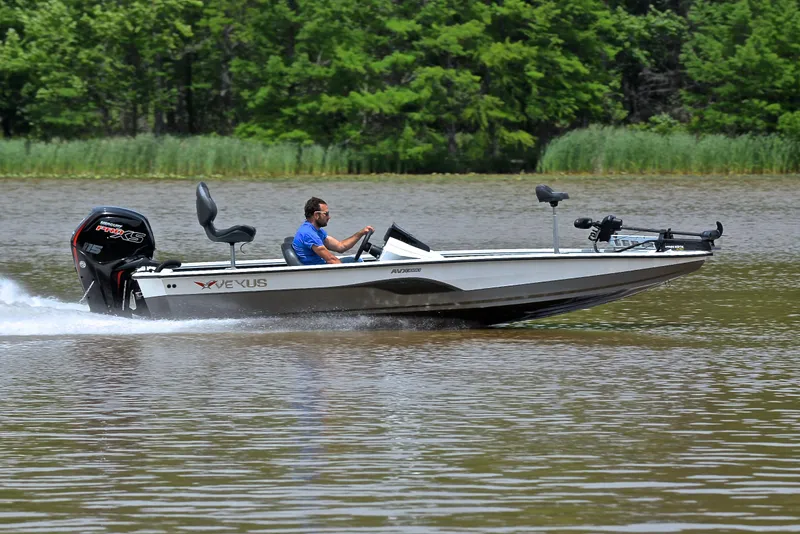 Slide: The Image of 2020 Vexus AVX1880 boat speeding on a lake with lush green trees in the background. - 3