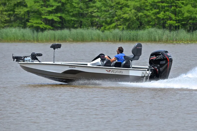 Slide: The Image of 2020 Vexus AVX1880 boat speeding on a lake with lush green background. - 4