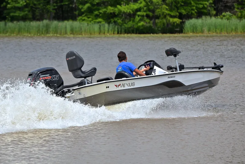 Slide: The Image of 2020 Vexus AVX1880 boat speeding on a lake with lush green background. - 5