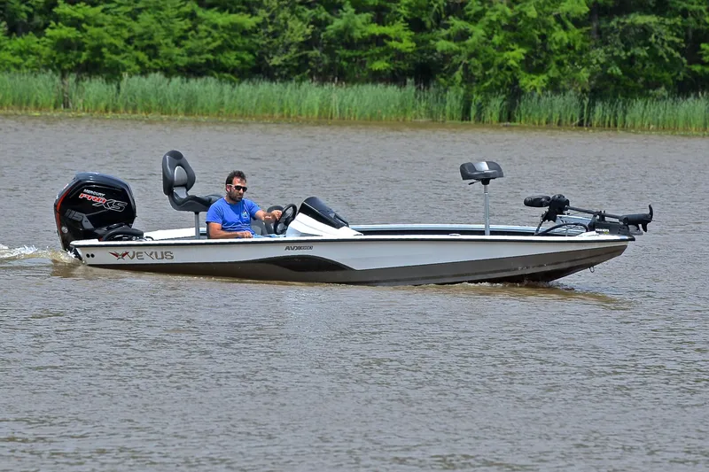 Slide: The Image of 2020 Vexus AVX1880 boat cruising on a lake with a person steering. - 7
