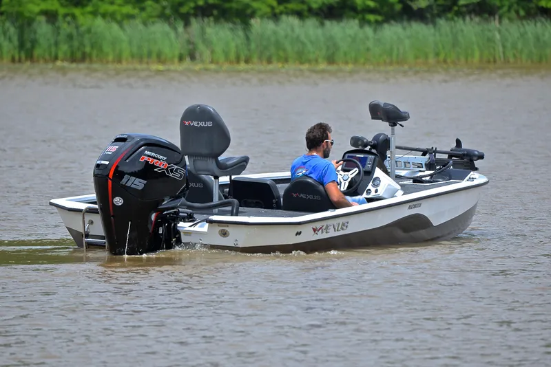Slide: The Image of 2020 Vexus AVX1880 boat on water with person driving, featuring a powerful outboard motor. - 8