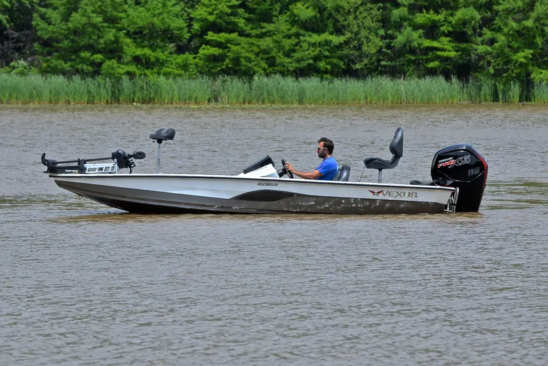 Slide: The Image of 2020 Vexus AVX1880 boat on a lake with a person driving. - 9