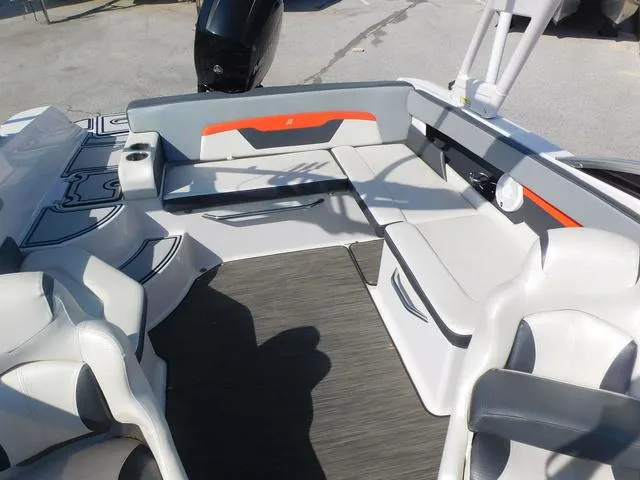 Slide: The Image of 2018 Four Winns HD 200 OB RS boat interior with gray and orange seating. - 11