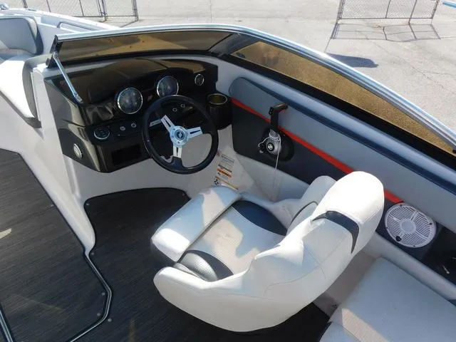 Slide: The Image of 2018 Four Winns HD 200 OB RS boat cockpit with steering wheel and white seating. - 7