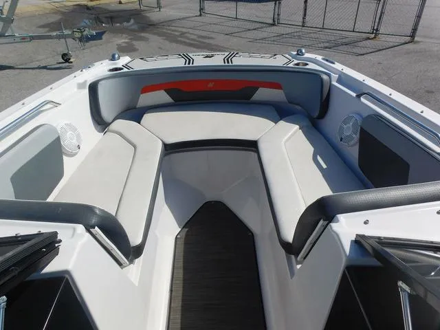 Slide: The Image of 2018 Four Winns HD 200 OB RS boat interior with cushioned seating and speakers. - 9