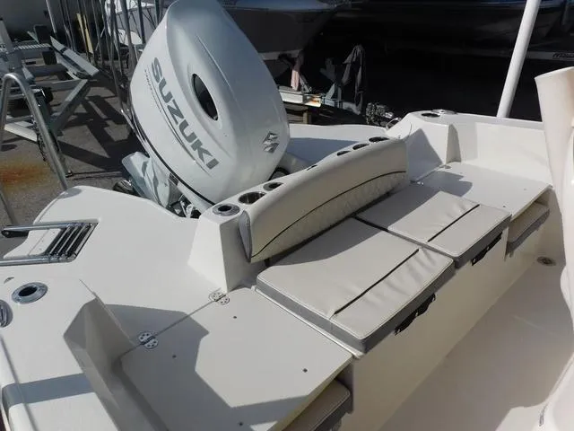 Slide: The Image of 2024 Stingray 216CC boat with Suzuki outboard motor and cushioned seating. - 11