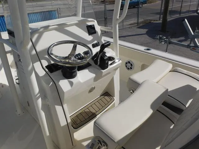 Slide: The Image of 2024 Stingray 216CC boat console with steering wheel and seating, showcasing modern design. - 14