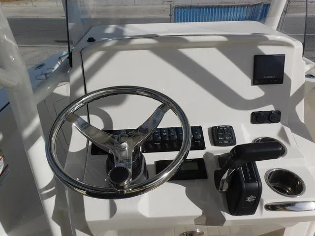 Slide: The Image of 2024 Stingray 216CC boat dashboard with steering wheel and controls. - 16