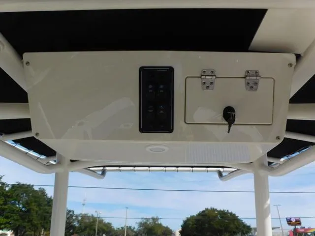 Slide: The Image of 2024 Stingray 216CC boat console with control panel and storage compartment. - 19