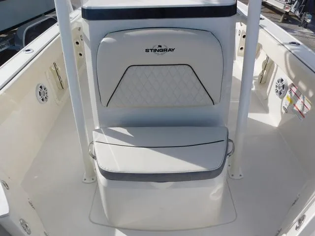 Slide: The Image of 2024 Stingray 216CC boat interior with cushioned seating and sleek design. - 26