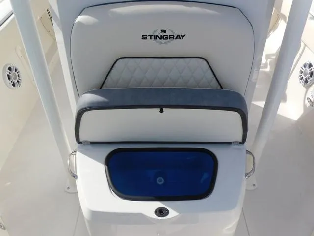 Slide: The Image of 2024 Stingray 216CC boat seat with storage compartment, featuring a sleek design and logo. - 27