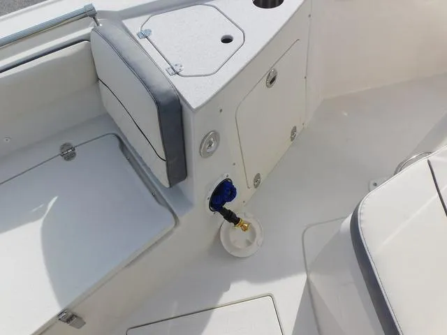 Slide: The Image of 2024 Stingray 216CC boat interior, featuring storage compartments and seating area. - 32