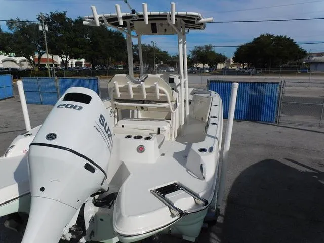 Slide: The Image of 2024 Stingray 216CC boat with Suzuki 200 engine, parked outdoors. - 8