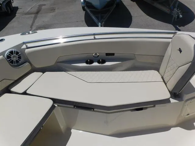Slide: The Image of 2024 Stingray 253CC boat interior with cushioned seating and cup holders. - 11