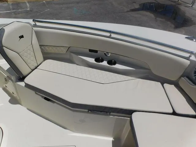 Slide: The Image of 2024 Stingray 253CC boat interior with cushioned seating and sleek design. - 12