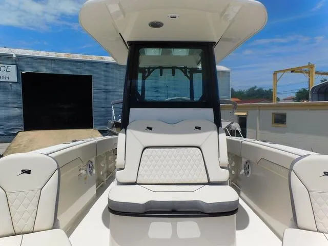 Slide: The Image of 2024 Stingray 253CC boat interior with cushioned seating and modern design. - 18