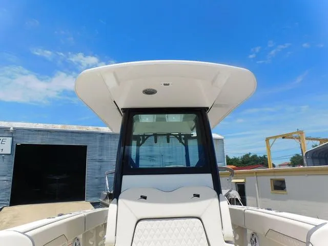 Slide: The Image of 2024 Stingray 253CC boat with sleek design under a clear blue sky. - 19