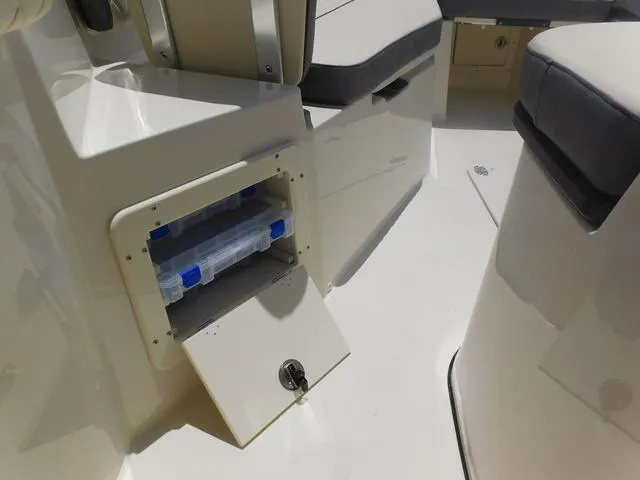 Slide: The Image of 2024 Stingray 253CC boat interior with open storage compartment and seating. - 21