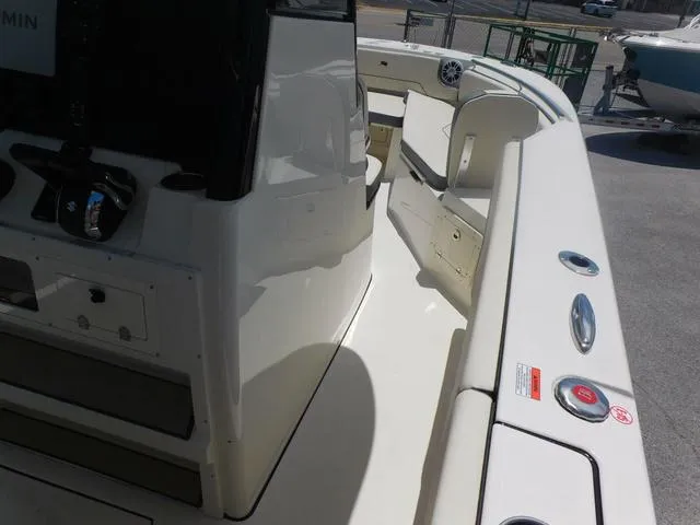 Slide: The Image of 2024 Stingray 253CC boat interior with sleek white design and modern controls. - 24