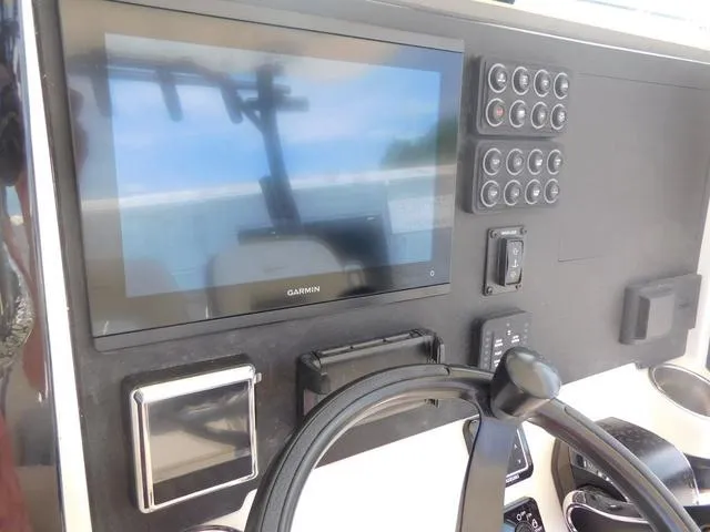 Slide: The Image of 2024 Stingray 253CC dashboard with Garmin display and control panel. - 26
