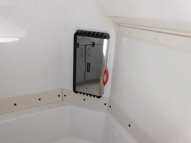 Slide: The Image of 2024 Stingray 253CC boat interior with mounted mirror and sleek white finish. - 33