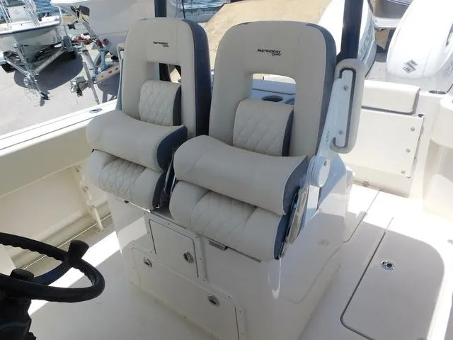 Slide: The Image of 2024 Stingray 253CC boat interior with dual cushioned seats and steering wheel. - 37