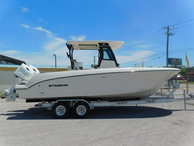 Slide: The Image of 2024 Stingray 253CC boat on trailer under clear blue sky. - 4