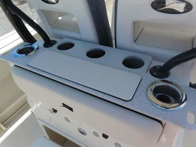 Slide: The Image of 2024 Stingray 253CC boat console with cup holders and storage compartments. - 40