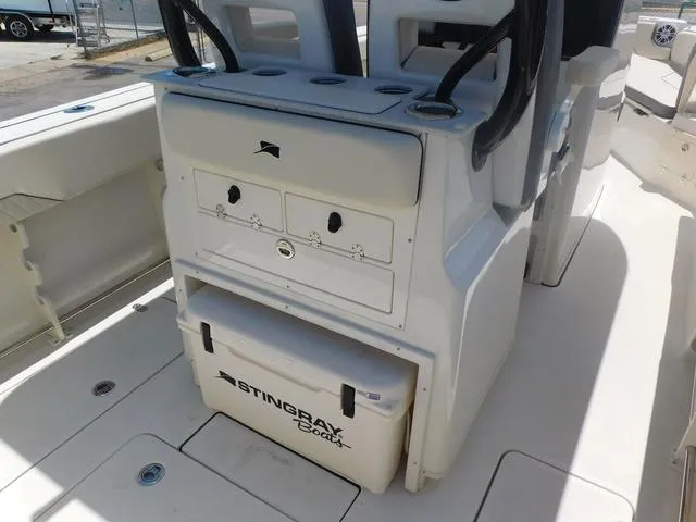 Slide: The Image of 2024 Stingray 253CC boat interior with storage and cooler. - 41