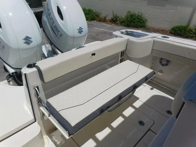 Slide: The Image of 2024 Stingray 253CC boat with Suzuki engines, featuring a foldable rear bench seat. - 43