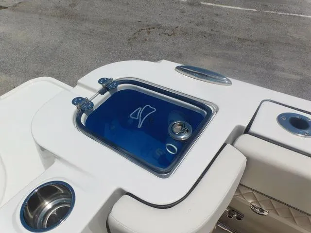Slide: The Image of 2024 Stingray 253CC boat's livewell with blue interior and cup holders. - 44