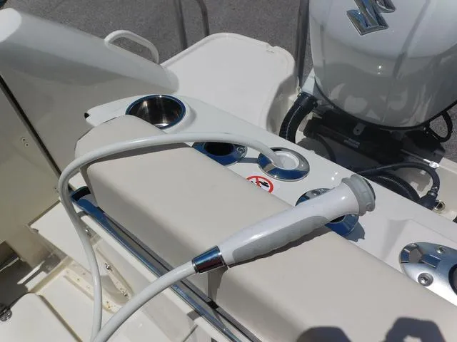 Slide: The Image of 2024 Stingray 253CC boat interior with cup holders and hose attachment. - 49