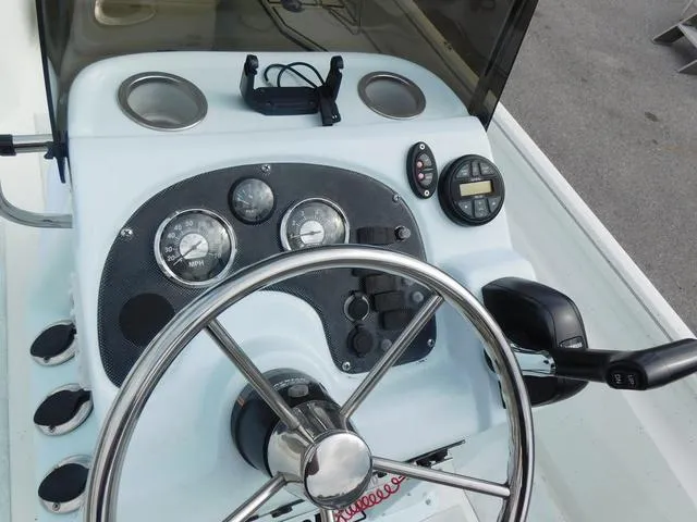 Slide: The Image of 2018 Excel Boats Bay Pro 220 dashboard with steering wheel and gauges. - 13