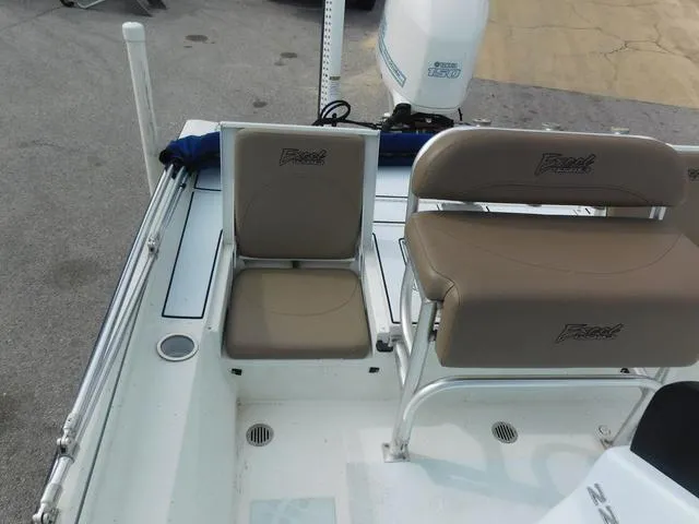 Slide: The Image of 2018 Excel Boats Bay Pro 220 interior with seating and motor detail. - 16
