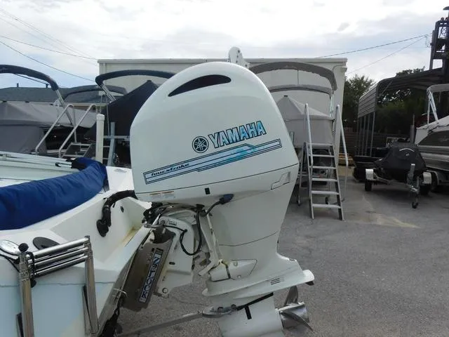 Slide: The Image of 2018 Excel Boats Bay Pro 220 with Yamaha outboard motor in a marina setting. - 5