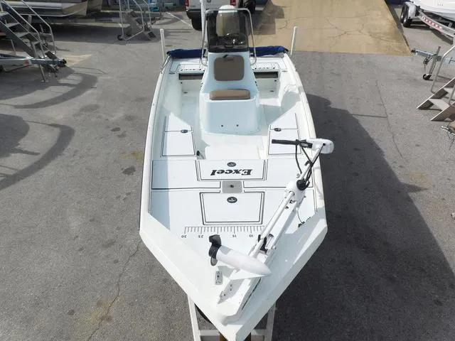 Slide: The Image of 2018 Excel Boats Bay Pro 220, white fishing boat, docked on trailer, top view. - 6