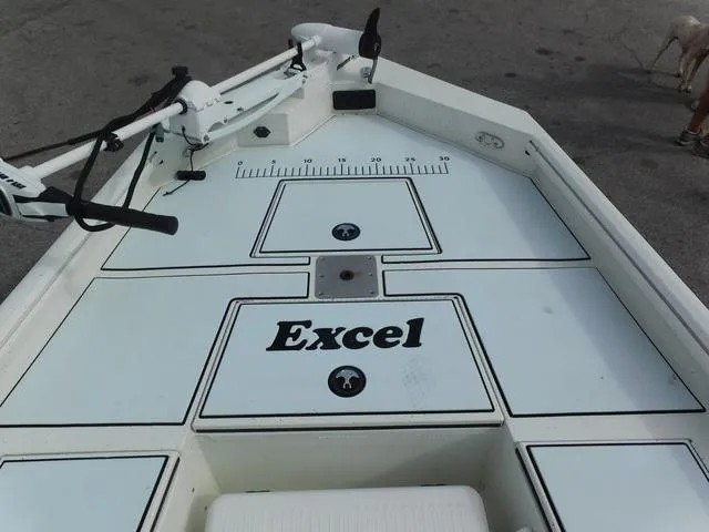 Slide: The Image of 2018 Excel Boats Bay Pro 220 deck with storage compartments and measuring ruler. - 8