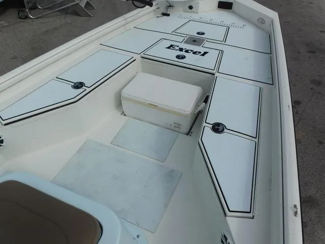 Slide: The Image of 2018 Excel Boats Bay Pro 220 interior with storage compartments and seating. - 9